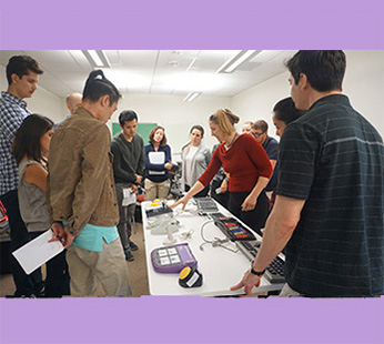 Staff member demonstrating assistive tech.